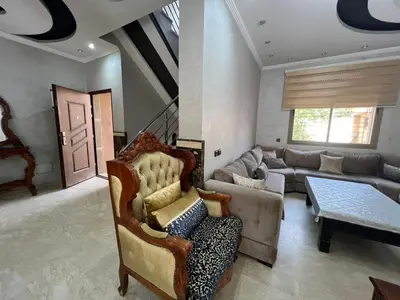 a living room with a couch and a table at Villa zinaya in Marrakech