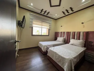 a bedroom with two beds and a window at Villa zinaya in Marrakech