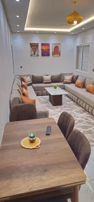 a large living room with a table and a couch at Central Bright Comfortable in Marrakech