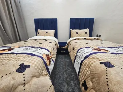 a bedroom with two beds with cats on them at Central Bright Comfortable in Marrakech