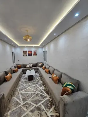 a large living room with a couch and a table at Central Bright Comfortable in Marrakech