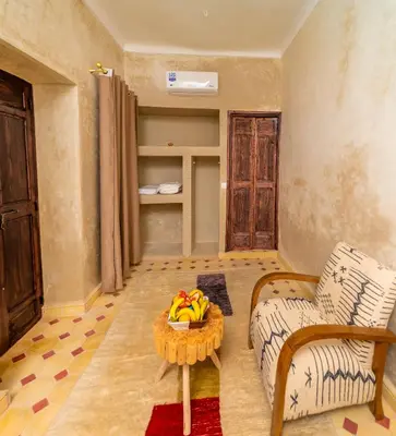 a living room with a table with bananas on it at Riad Lalla Fatima Marrakech in Marrakech