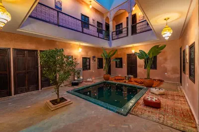 a house with a pool in the middle of a room at Riad Lalla Fatima Marrakech in Marrakech