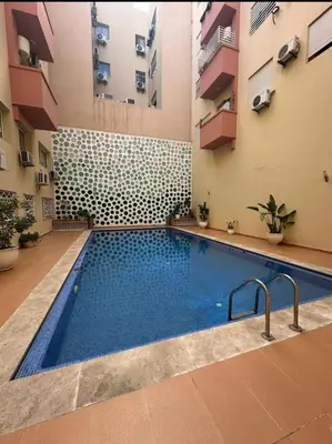 a swimming pool in the middle of a building at Superbe Duplex moderne à Izdihar in Marrakech
