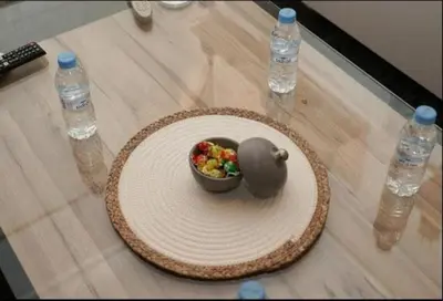 a bowl of fruit on a table with water bottles at Superbe Duplex moderne à Izdihar in Marrakech