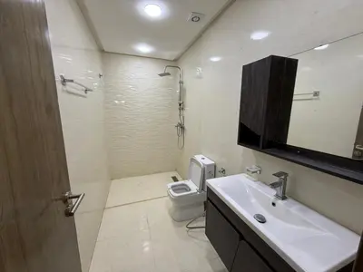 a bathroom with a sink and a toilet and a mirror at حدائق حي شريفية بوعكاز مراكش in Marrakech