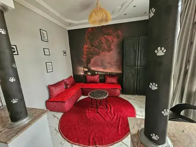 a living room with a red couch and a red rug at la villa cozy in Marrakech