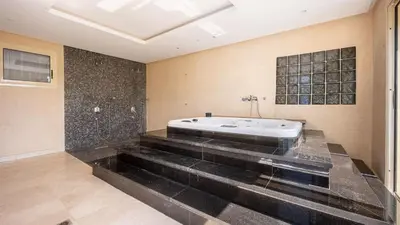 a bathroom with a bath tub in a room at Villa de luxe in Marrakech