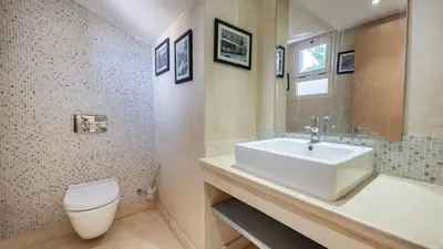 a bathroom with a white sink and a toilet at Villa de luxe in Marrakech