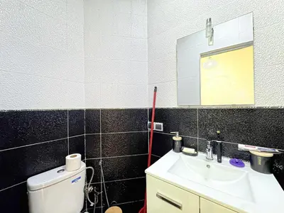 a bathroom with a sink and a mirror and a toilet at Elegance and comfort in Marrakech Top Location in Marrakech