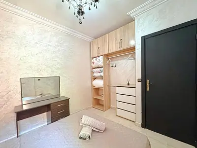 a bedroom with a bed and a mirror and a black door at Elegance and comfort in Marrakech Top Location in Marrakech