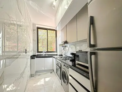 a kitchen with a refrigerator and a stove top oven at Elegance and comfort in Marrakech Top Location in Marrakech