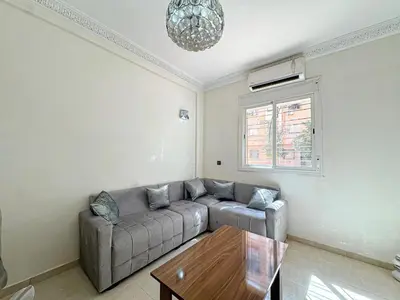 a living room with a couch and a table at Elegance and comfort in Marrakech Top Location in Marrakech