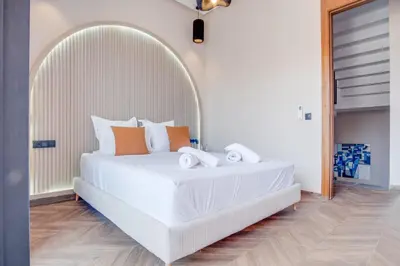 a bedroom with a large white bed with orange pillows at Villa joud in Marrakech