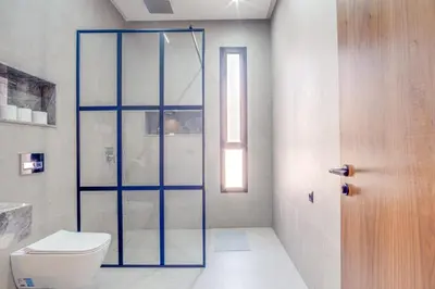 a bathroom with a toilet and a glass shower at Villa joud in Marrakech