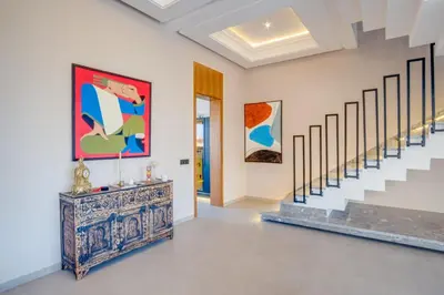 a room with stairs and paintings on the walls at Villa joud in Marrakech