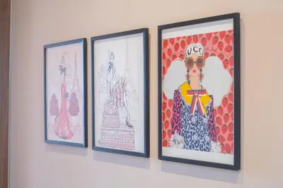 four framed drawings of women on a wall at Villa joud in Marrakech