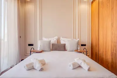 a large white bed with two towels on it at Villa joud in Marrakech