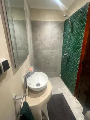 a bathroom with a sink and a shower at Riad Nora - Confort, Calme & Sécurité in Marrakech