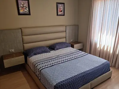 a bedroom with a bed with a blue comforter at marrakech village in Marrakech