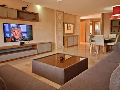 a living room with a couch and a tv at marrakech village in Marrakech