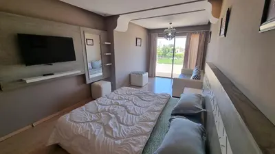 a bedroom with a bed and a flat screen tv at marrakech village in Marrakech