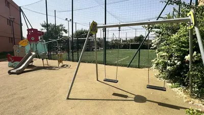 a playground with swings and a tennis court at Domaine Noria - Modern apartment, quiet & 4 pools in Marrakech