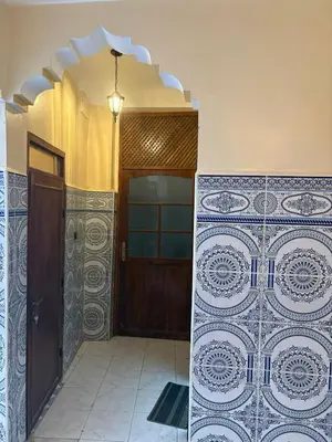 an entrance to a house with a door and tiles at Dar Adil à 5 min from Jemaa el fna médina in Marrakech
