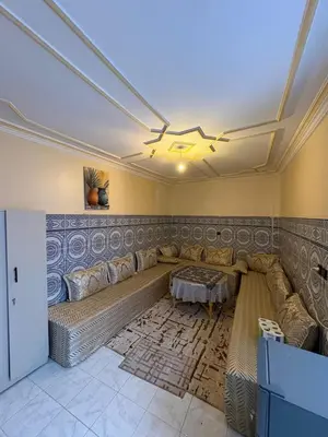a living room with a couch and a table at Dar Adil à 5 min from Jemaa el fna médina in Marrakech