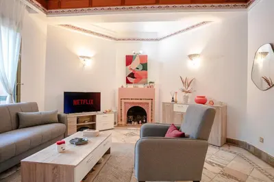 a living room with two couches and a fireplace at Marrakech Palmeraie 2, 2-bedroom appartment, G1 , swimming pool residence, in Marrakech