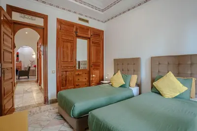 a bedroom with two beds and a mirror at Marrakech Palmeraie 2, 2-bedroom appartment, G1 , swimming pool residence, in Marrakech