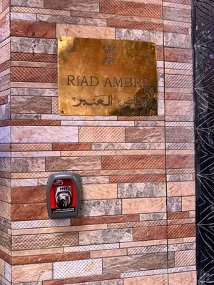 a sign on a wall with a clock on it at Riyad Ambre in Marrakech
