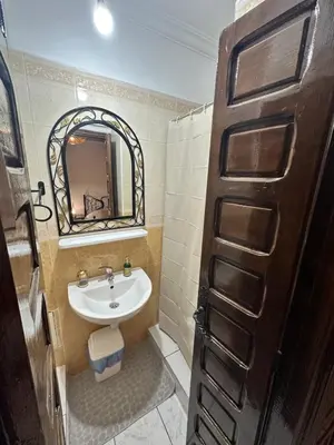 a bathroom with a sink and a mirror at Riyad Ambre in Marrakech