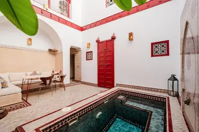 a house with a swimming pool in a living room at Authentic Guesthouse Peral in the heart of Medina in Marrakech