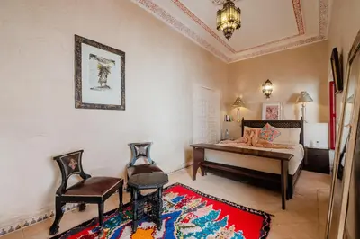 a bedroom with a bed and a desk and a chair at Authentic Guesthouse Peral in the heart of Medina in Marrakech