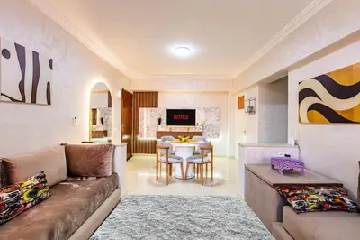 a living room with a couch and a table at Stylish Apartment in Gueliz by Train And Majorelle in Marrakech