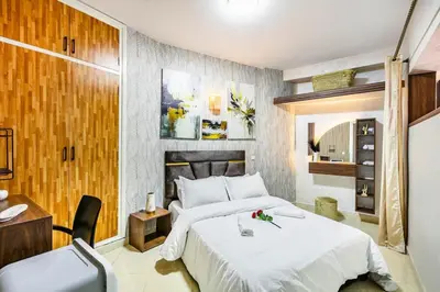 a bedroom with a large white bed and a desk at Stylish Apartment in Gueliz by Train And Majorelle in Marrakech