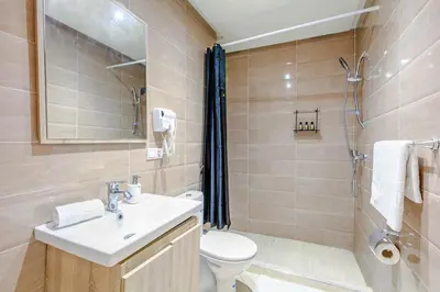 a bathroom with a sink and a toilet and a shower at Stylish Apartment in Gueliz by Train And Majorelle in Marrakech
