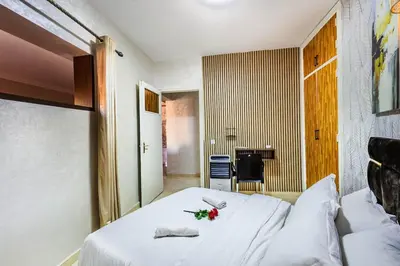a bedroom with a white bed with flowers on it at Stylish Apartment in Gueliz by Train And Majorelle in Marrakech