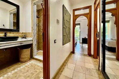 a bathroom with a sink and a mirror at Apartment with big private garden in Palmeraie in Marrakech