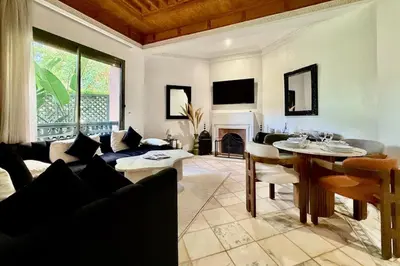 a living room with a couch and a table at Apartment with big private garden in Palmeraie in Marrakech