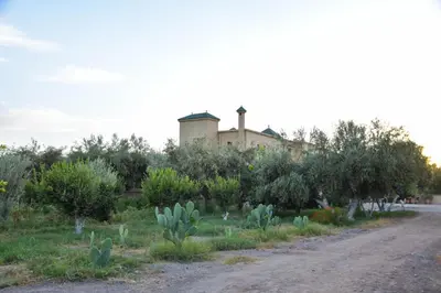 a dirt road with a house in the background at Bluegreen Guest House Marrakech in Aït Amara