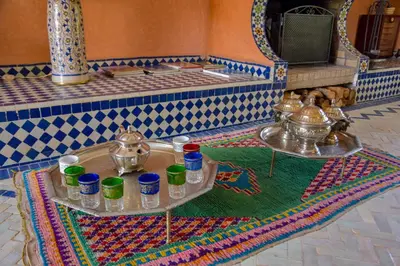 a room with a table with cups and dishes on it at Bluegreen Guest House Marrakech in Aït Amara