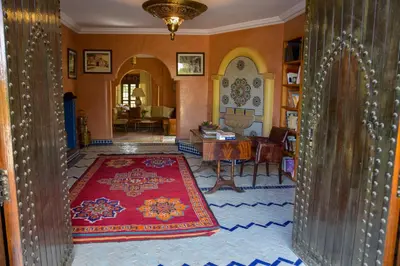 a living room with a red rug on the floor at Bluegreen Guest House Marrakech in Aït Amara