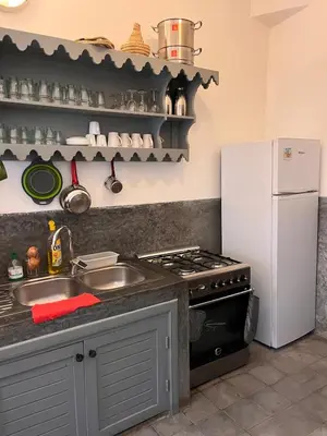 a kitchen with a sink and a white refrigerator at Riad privé 3 chambres, pdj inclus, 10 min Jema El Fna in Marrakech