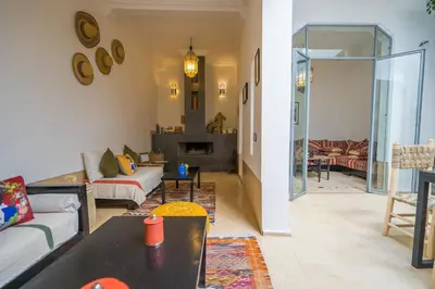 a living room with a couch and a table at Riad privé 3 chambres, pdj inclus, 10 min Jema El Fna in Marrakech