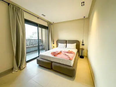 a bedroom with a bed and a large window at Villa CAN 2025 & Chill Marrakech in Dar Caïd Layadi