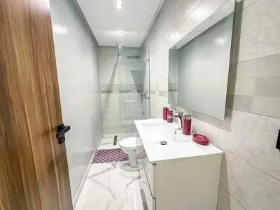 a bathroom with a sink and a toilet and a mirror at Villa CAN 2025 & Chill Marrakech in Dar Caïd Layadi