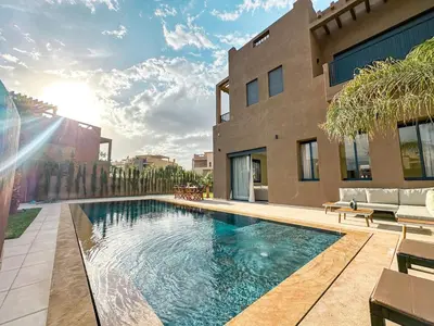 a swimming pool in front of a house at Villa CAN 2025 & Chill Marrakech in Dar Caïd Layadi