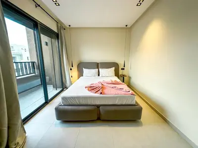 a bed in a room with a large window at Villa CAN 2025 & Chill Marrakech in Dar Caïd Layadi